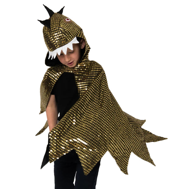 Child wearing a gold sequin dragon costume on a plain background